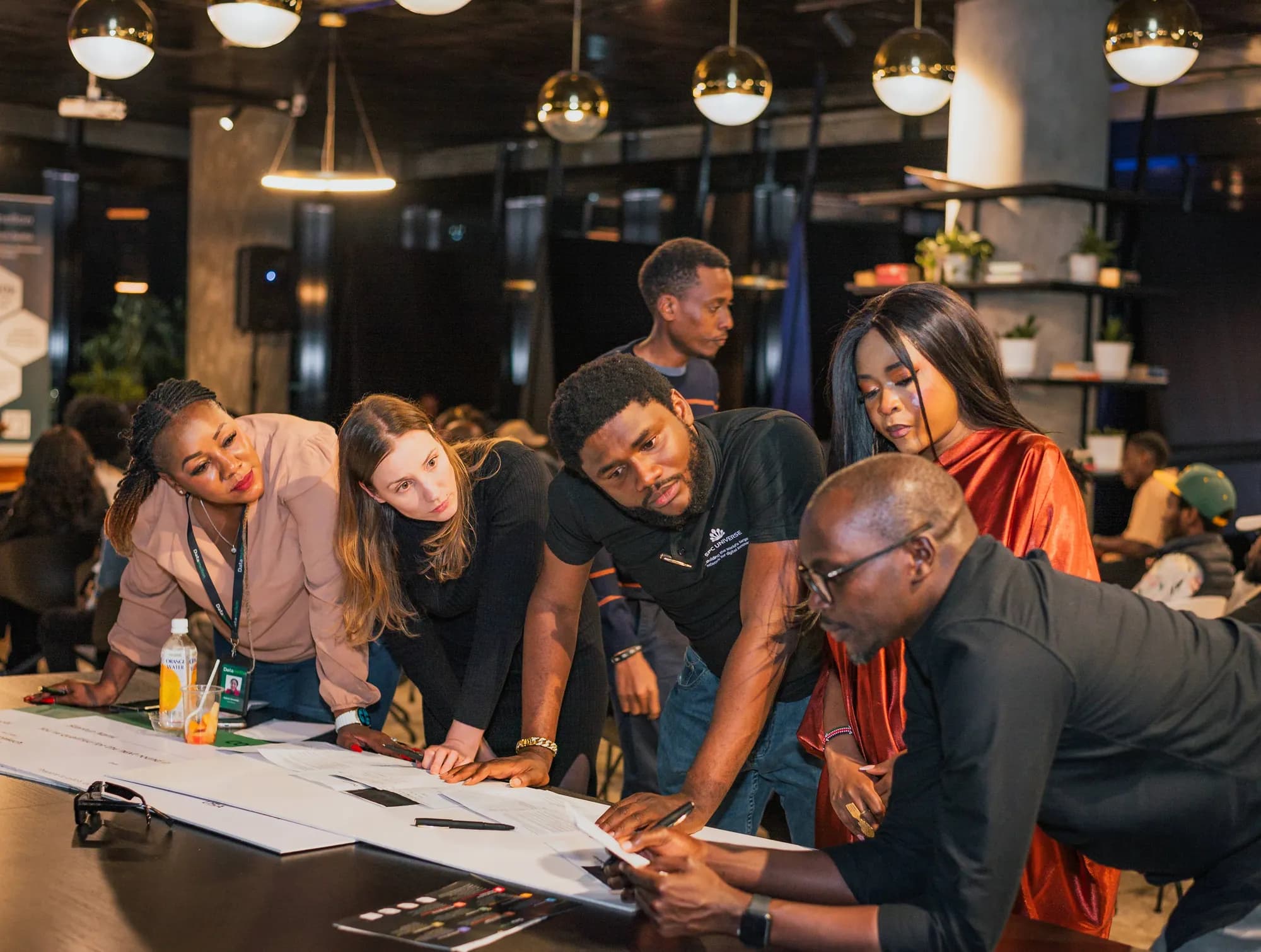 Participants work together around a table at the Datamellon AI Event